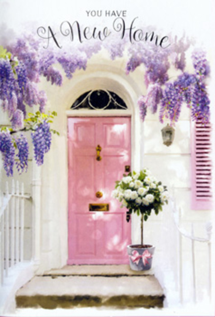A sunlit doorway in Abbey Wood becomes a poetic still life of welcome in this scene, where architecture and flowers work together like a thoughtful housewarming card brought to life. The front door, painted a gentle, almost chalky pink, stands tall against smooth whitewashed walls and a single pale shutter, the understated backdrop allowing the florals to truly sing. Wisteria drapes above in lush, flowing strands of lavender and soft mauve, the blossoms hanging in tiered clusters that sway as if catching a light wind that might have drifted through from Bostall Woods. The vines frame the doorway with a natural arch, their tendrils softening the lines of the building and adding a dreamy, romantic quality that feels both old-world and very much at home in South-East London. At the base of the door, set squarely on the step, sits a rustic-style metal bucket with a cool grey patina. From it spills a generous bouquet of white and cream roses, the blooms plush and fully open, each petal layered in spiral upon spiral. Threads of green foliage weave between them, adding texture and depth, like the hedgerows along quiet Abbey Wood side streets in late spring. A pink satin ribbon encircles the bucket, its bow resting lightly against the metal, echoing the door's colour and reinforcing a palette of soft, hopeful tones. The light is gentle, almost painterly, throwing faint shadows behind the petals and catching the edge of each rose so that they appear luminous. Everything about the image suggests the sweet nerves and optimism of moving day, making this the kind of floral arrangement you'd send to mark a new address in Abbey Wood with warmth, affection, and the promise of many happy years to come.
